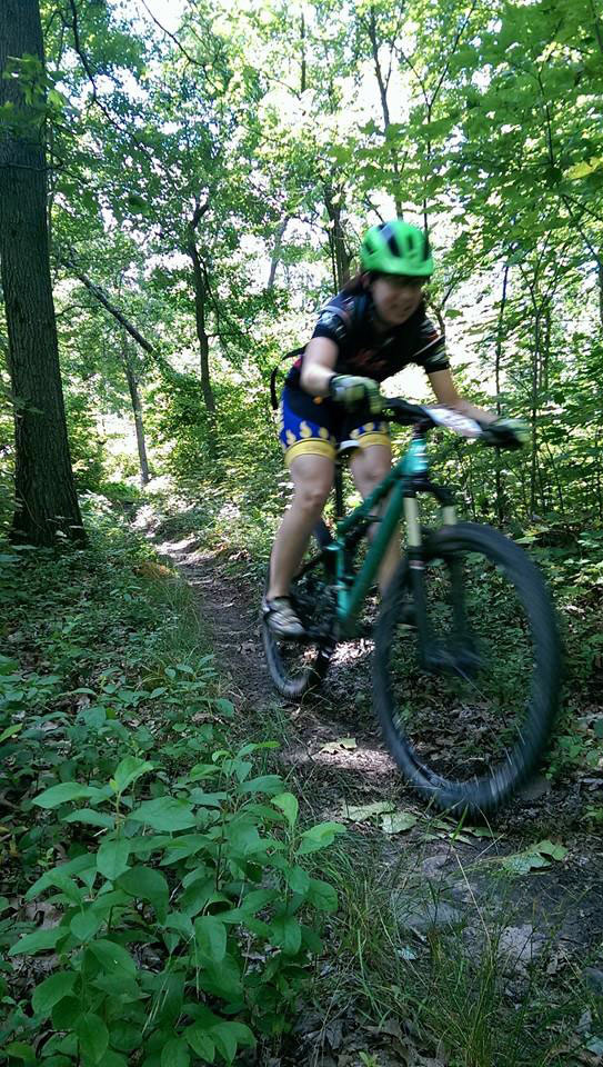Sara Harper bicycle racing through the woods