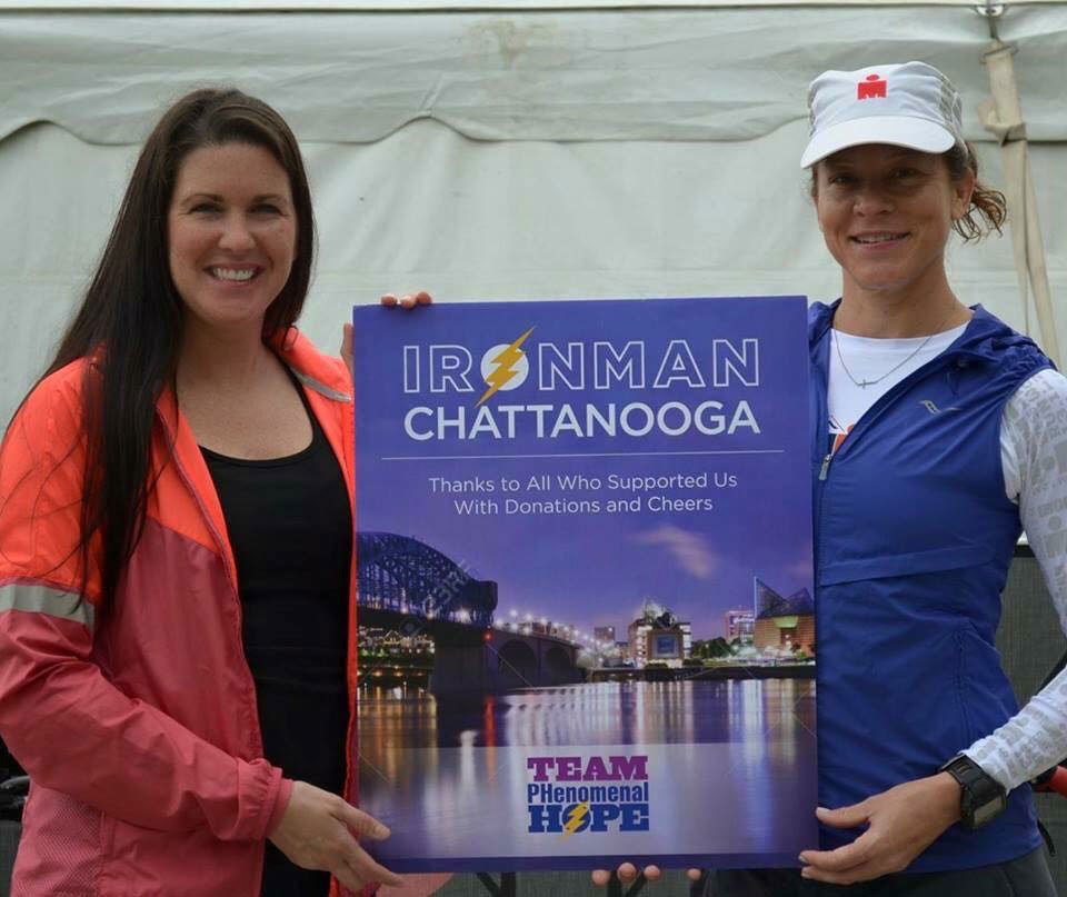 Monica and Amanada holding an Ironman Chattanooga Team PH sign