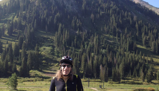 Hap Farber in front of a verdant mountain in summer