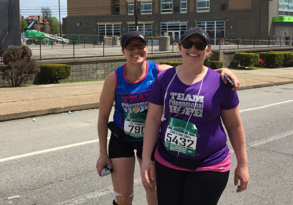 A pair of Team PHenomenal Hope runners catch up with one another for a duo photo during the 2015 Pittsburgh Marathon
