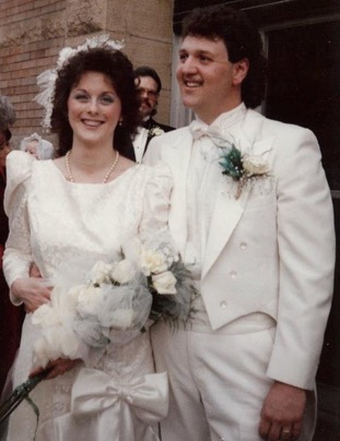 Beth and Dan Kolopajlo smiling at their wedding