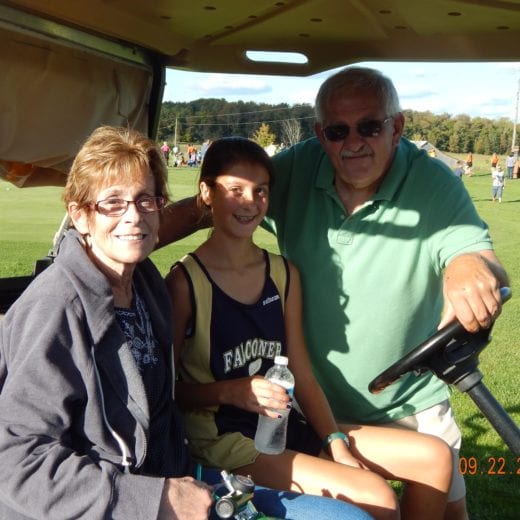 Cynthia pictured with her husband, Denny at her granddaughter's cross country meet. The home meets are held at a golf course and her son-in-law arranged for her to use a golf cart so she could follow the race. ( She always takes her oxygen off for photos.)