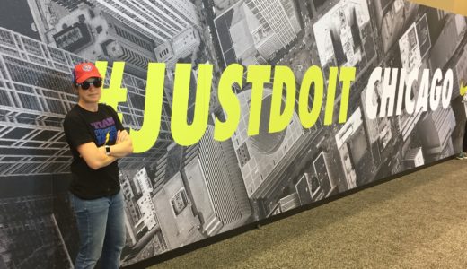 PG at the marathon expo, posing in front of the Just Do It sign